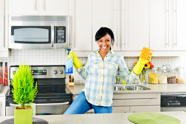 woman-cleaning-and-dancing-in-kitchen